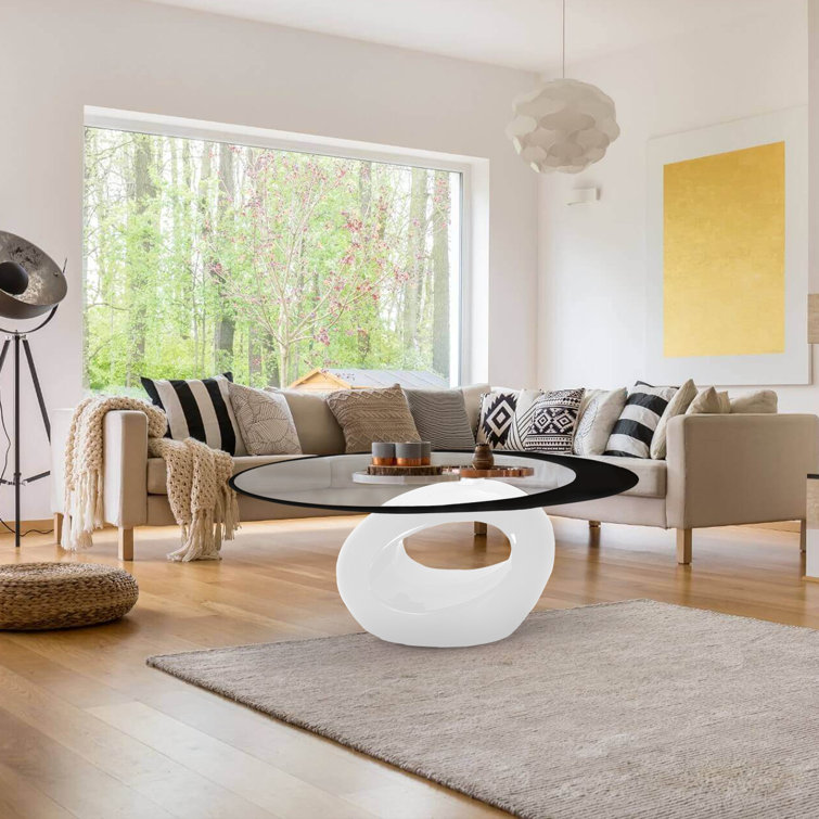 White Oval Glass Top Coffee Table with Abstract Base