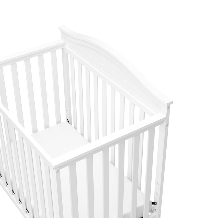 Stella White Pine Wood 4-in-1 Convertible Mini Crib with Foam Mattress