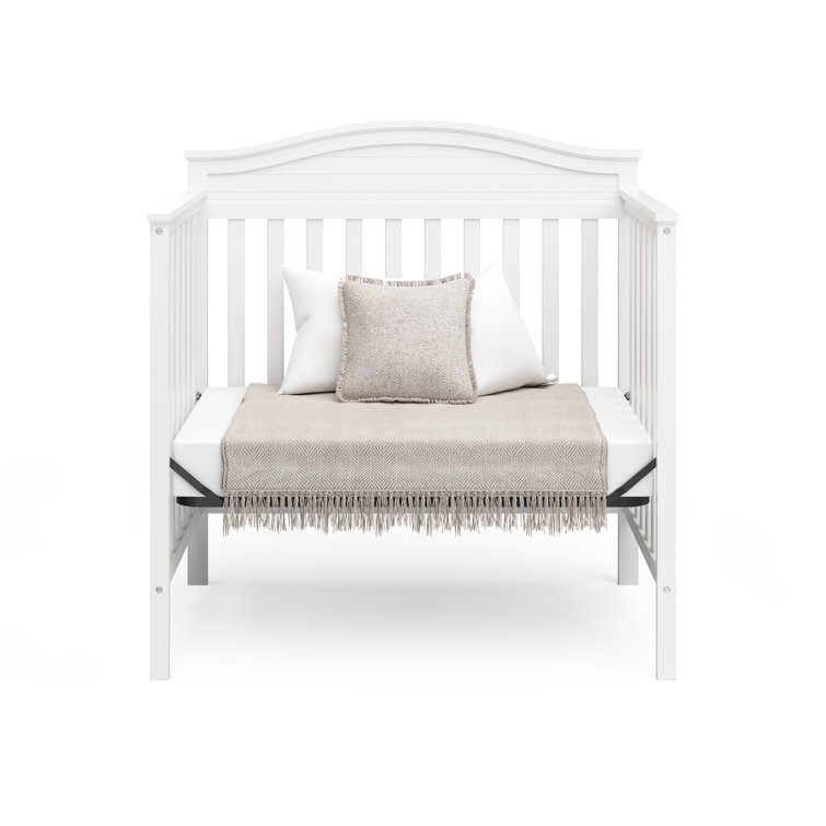 Stella White Pine Wood 4-in-1 Convertible Mini Crib with Foam Mattress