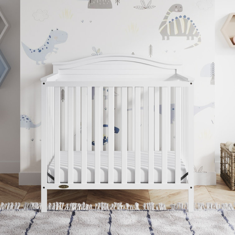 Stella White Pine Wood 4-in-1 Convertible Mini Crib with Foam Mattress