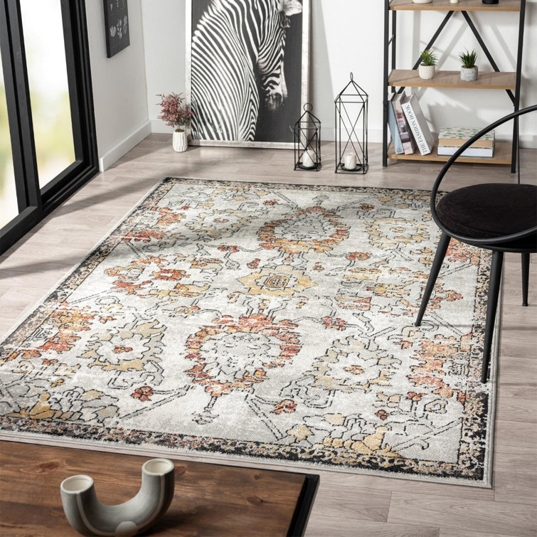 Distressed Orange and Beige Floral 6' x 9' Synthetic Area Rug