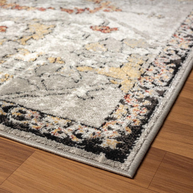 Distressed Orange and Beige Floral 6' x 9' Synthetic Area Rug