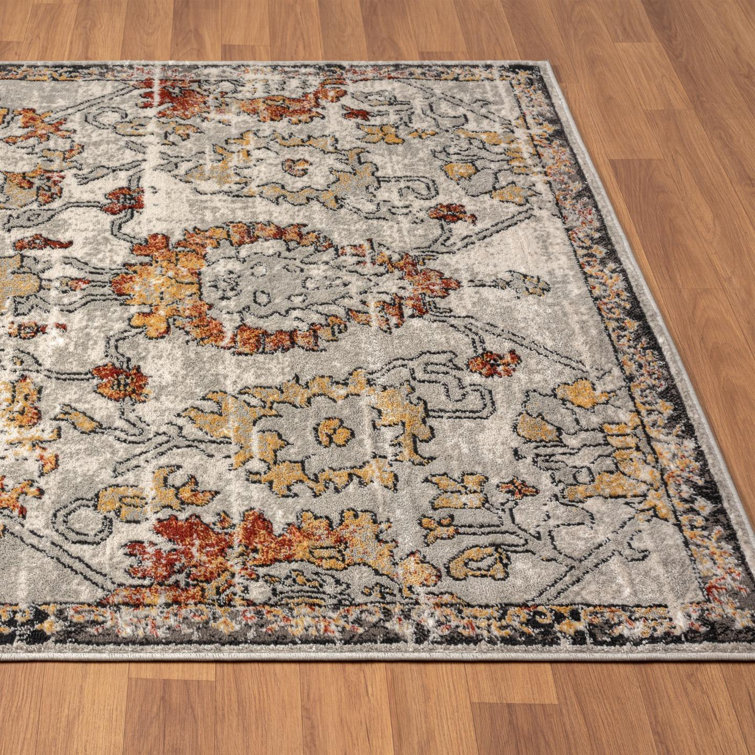 Distressed Orange and Beige Floral 6' x 9' Synthetic Area Rug