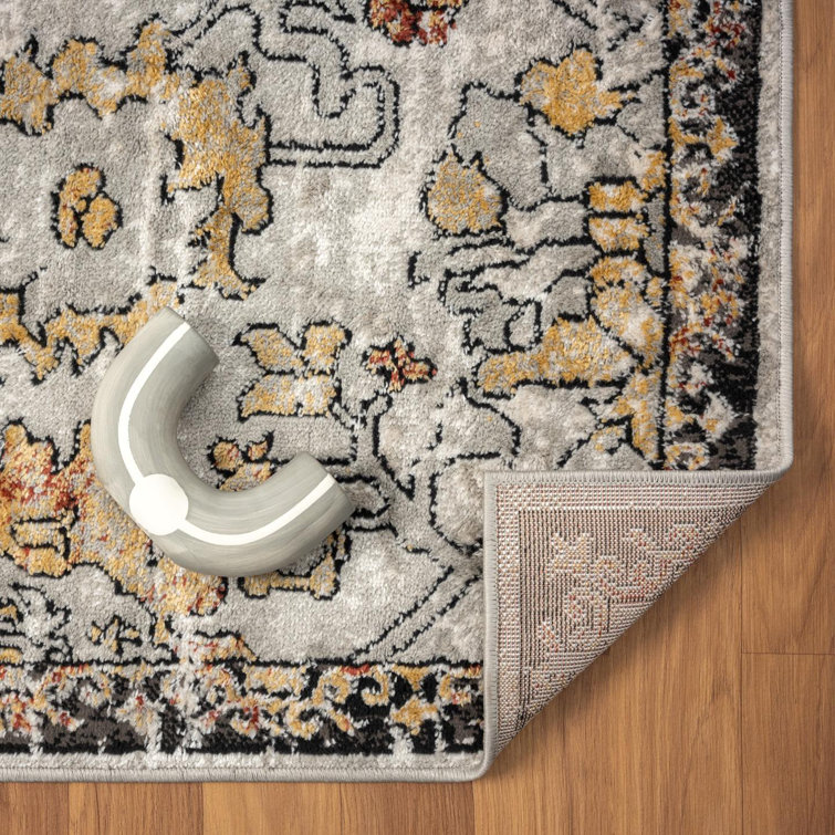 Distressed Orange and Beige Floral 6' x 9' Synthetic Area Rug