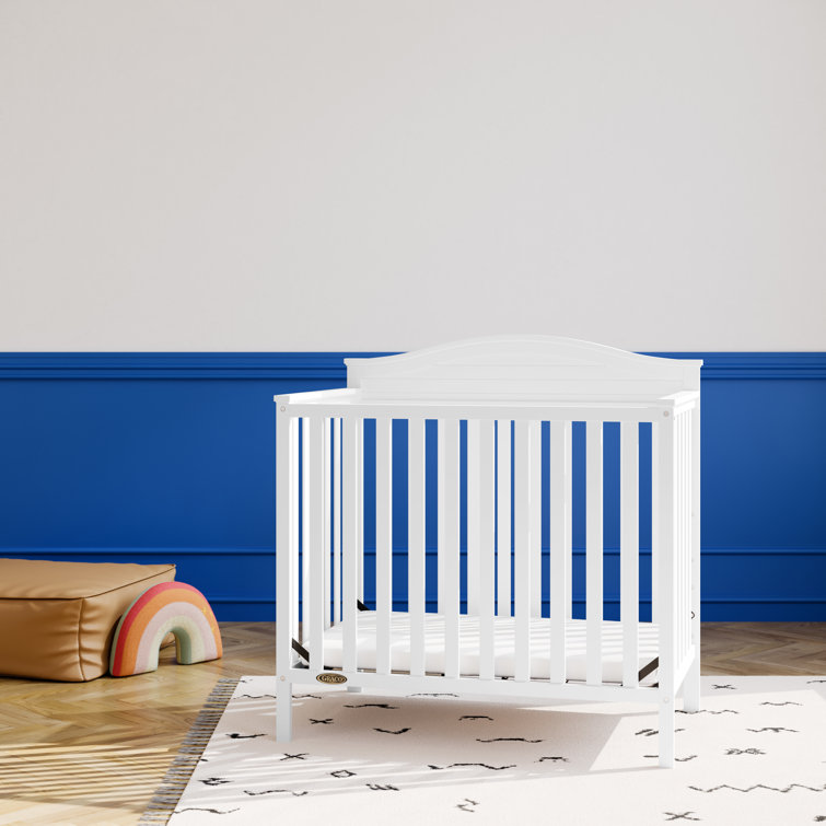 Stella White Pine Wood 4-in-1 Convertible Mini Crib with Foam Mattress
