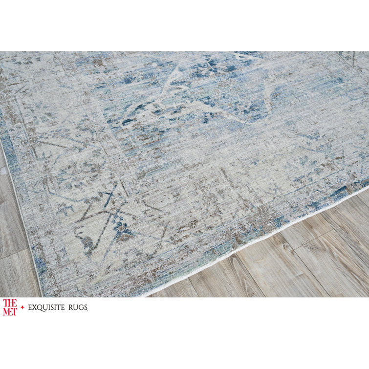 Vintage Inspired Light Blue and Beige 10' x 14' Synthetic Area Rug