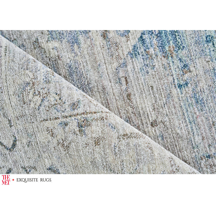 Vintage Inspired Light Blue and Beige 10' x 14' Synthetic Area Rug