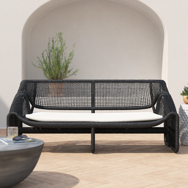 Curved Black Wicker Outdoor Sectional Sofa with White Cushions