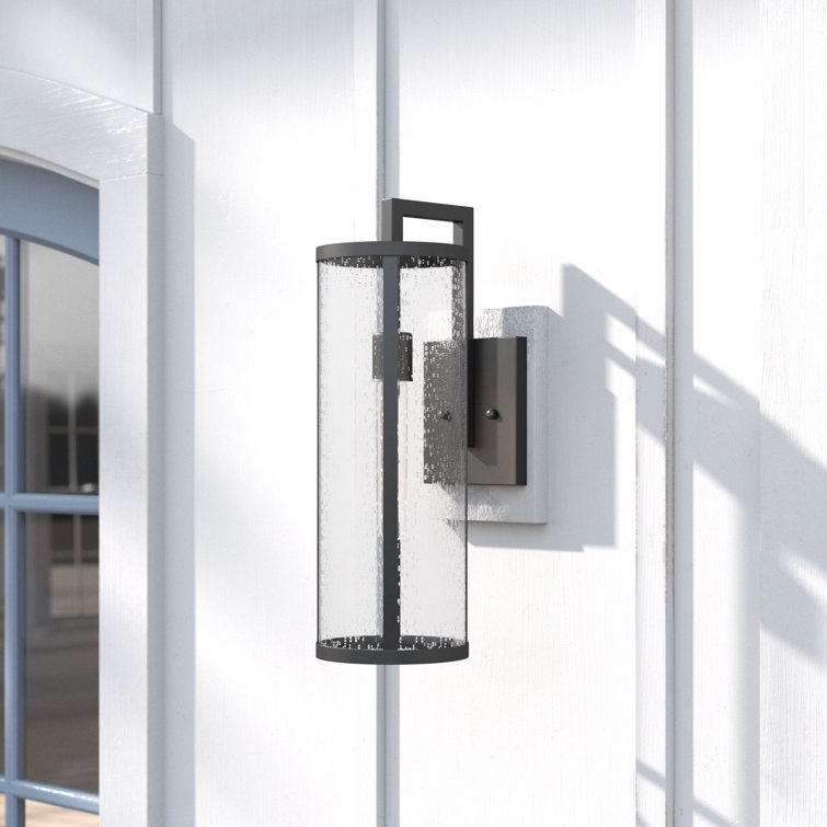 Medium Black Aluminum Cylinder Outdoor Wall Light with Seeded Glass