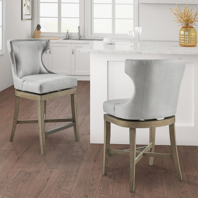 Elegant Light Grey Wingback Swivel Counter Stool with Bronze Accents