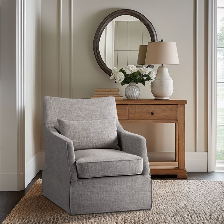 Gray Skirted Swivel Armchair with Lumbar Pillow