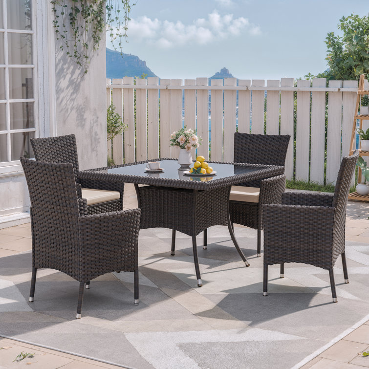 5-Piece Dark Brown Rattan Outdoor Dining Set with Sand Cushions and Glass Tabletop
