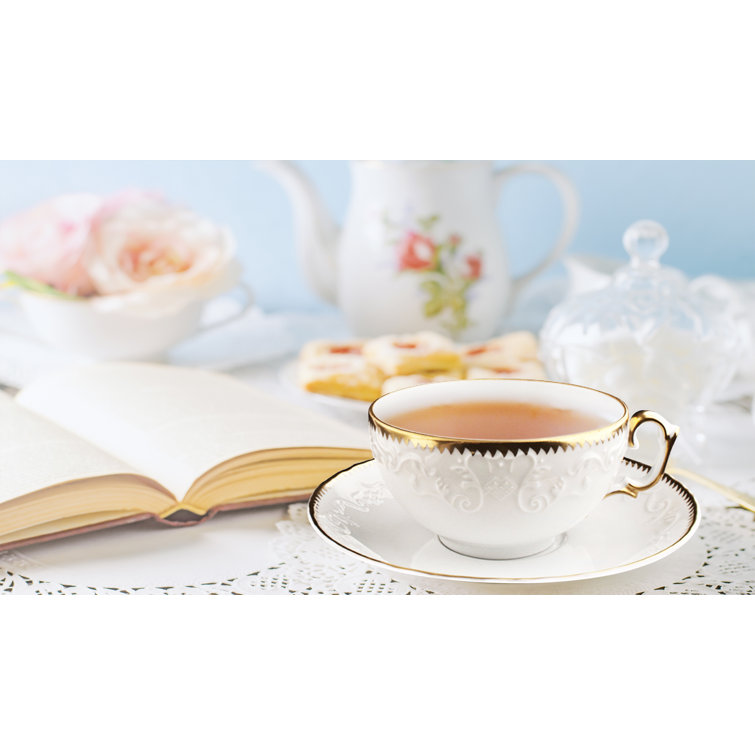 Elegant White Ceramic Teacup with Platinum Detailing and Saucer