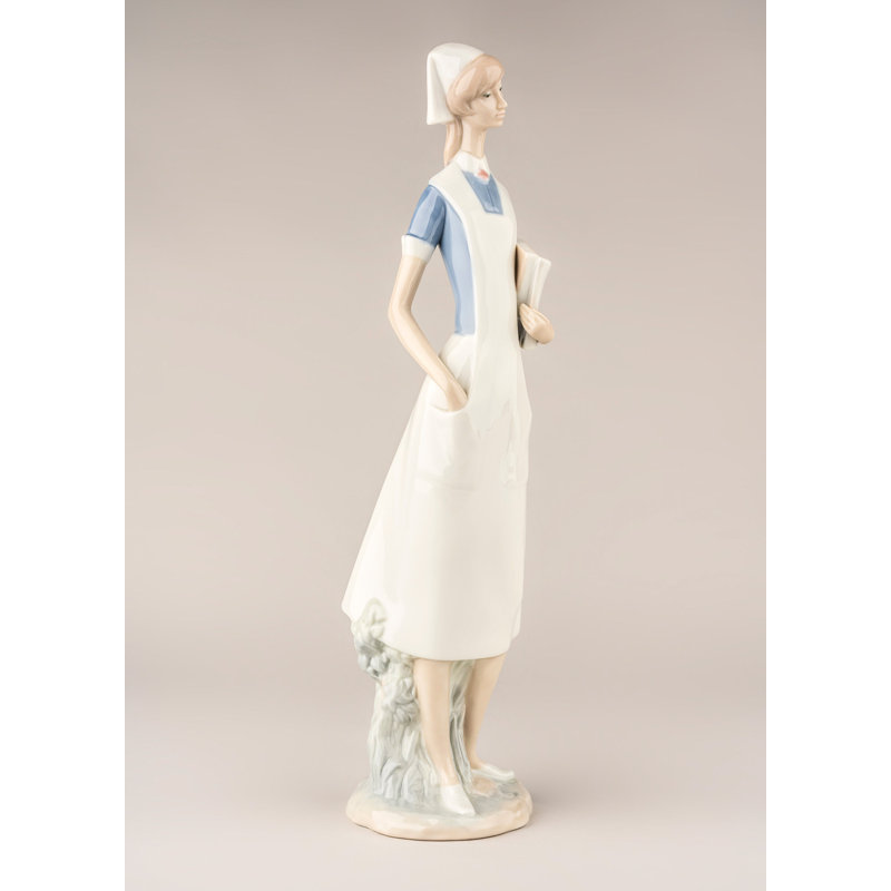 Matte White Porcelain Nurse Figurine with Delicate Petal Details
