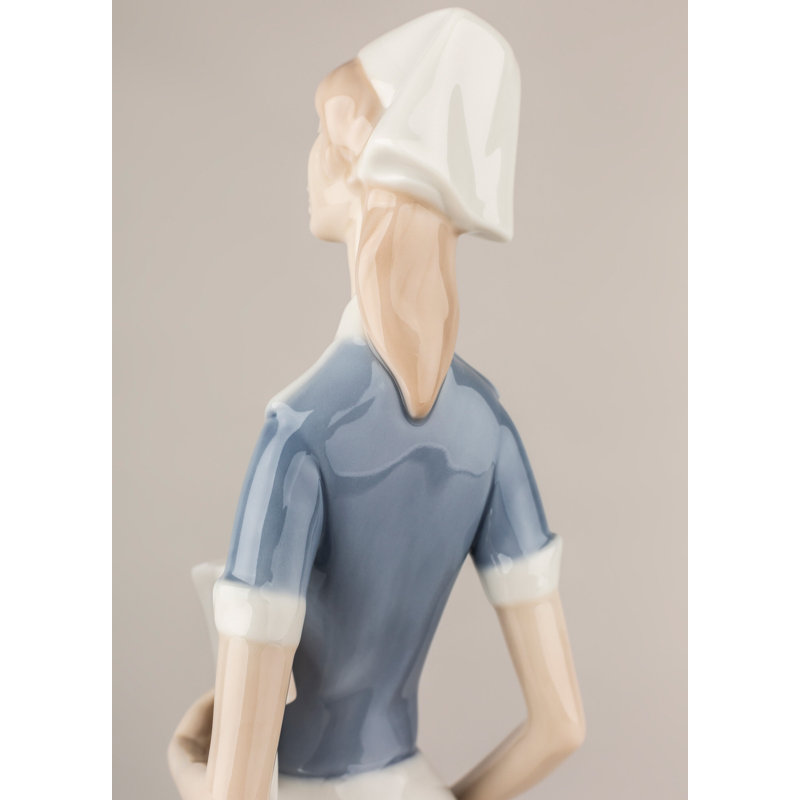 Matte White Porcelain Nurse Figurine with Delicate Petal Details