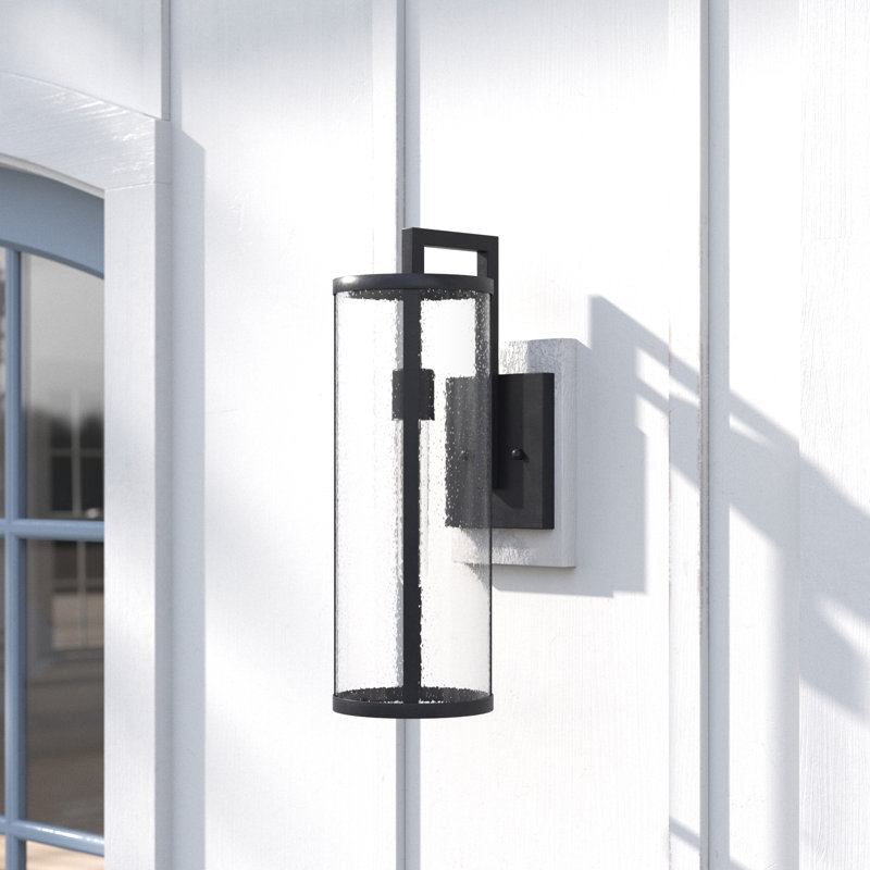 Medium Black Aluminum Cylinder Outdoor Wall Light with Seeded Glass