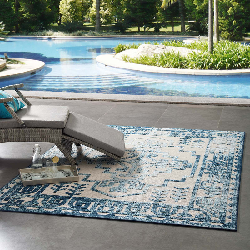 Ivory and Blue Geometric Synthetic 5' x 8' Area Rug