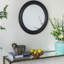 Miroir mural circulaire avec cadre en bois noir