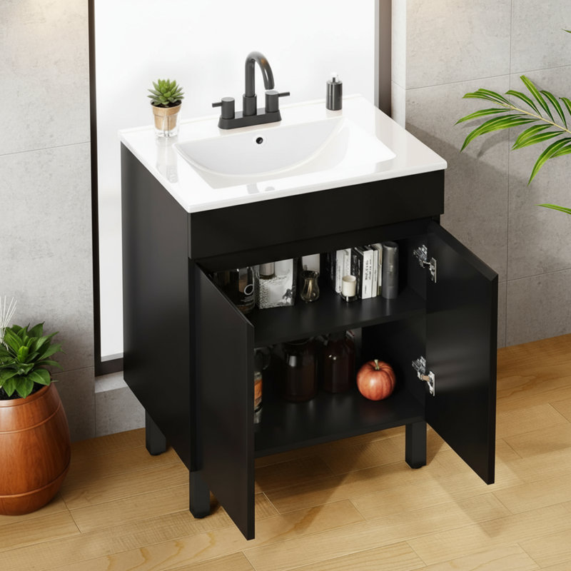 Un meuble-lavabo noir moderne avec un lavabo encastré et des armoires compactes, des pieds réglables, deux grandes portes à fermeture en douceur et un drain; Peu encombrant et élégant.