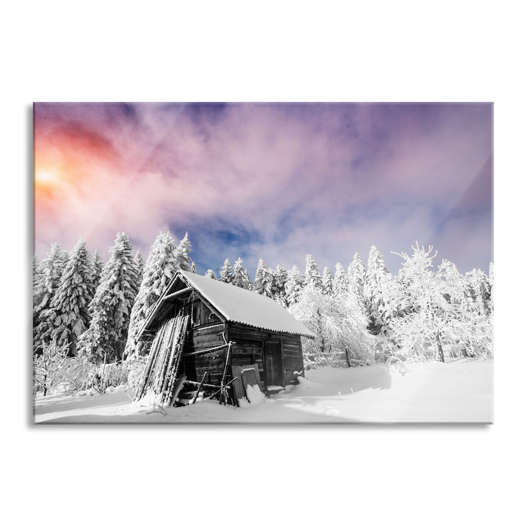 Glasbild Holzhütte im Schnee