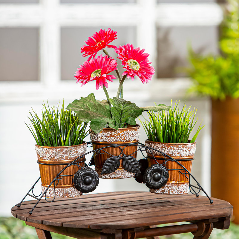 JardiniÃ¨res en mÃ©tal avec ornements en pierre et support
