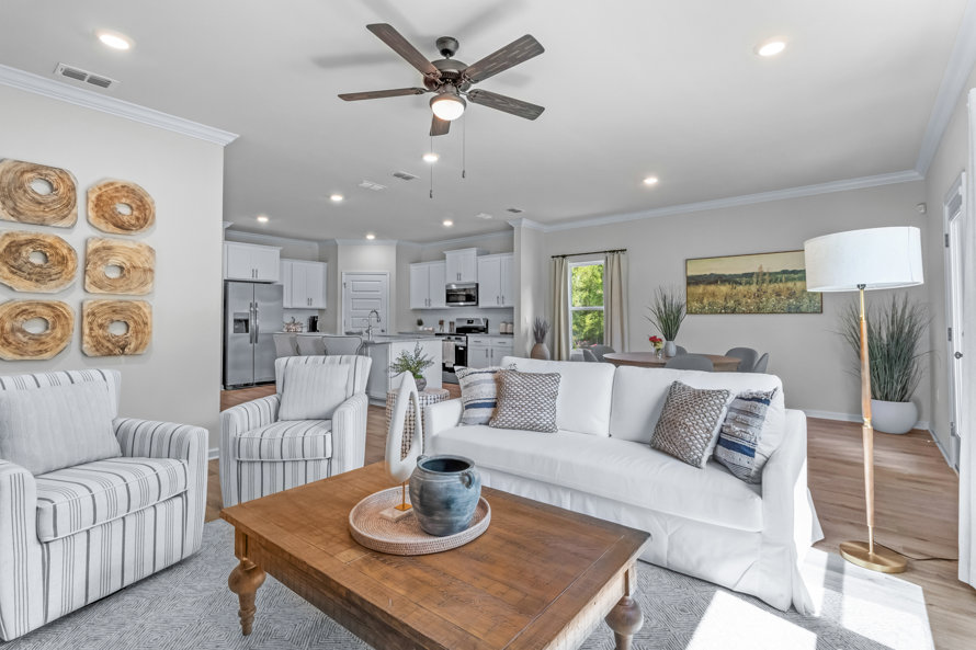 Living room with white sofa, striped chairs, and wood accents.