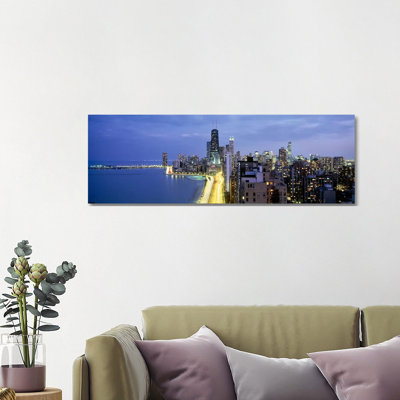 Skyscrapers Lit Up At The Waterfront, Lake Shore Drive, Chicago, Cook County, Illinois, USA by Panoramic Images - Wrapped Canvas Panoramic Print