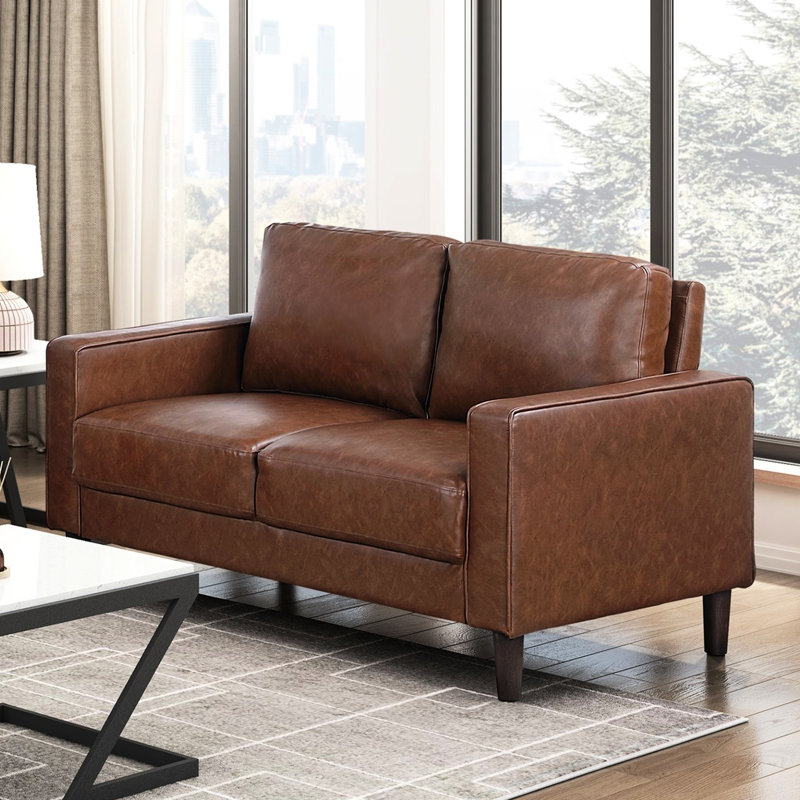 Causeuse transitionnelle en similicuir chocolat avec accoudoirs et passepoil pour un décor rustique - Style Modern Living Espaces