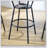 Round bar table and stool set with shelf, upholstered stool with backrest