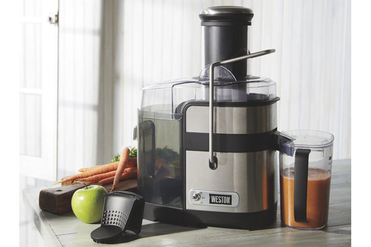 Juicer next to carrots and apple