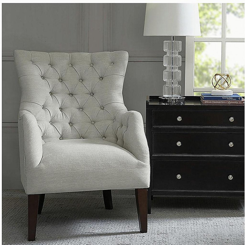 Fauteuil à oreilles capitonné