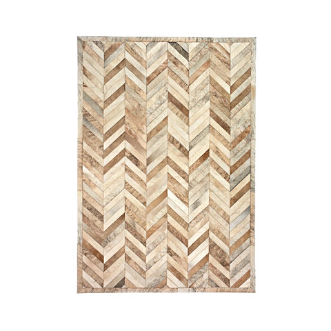 Rectangular area rug featuring a natural cowhide herringbone pattern in various shades of tan, brown, and cream with a matching border.