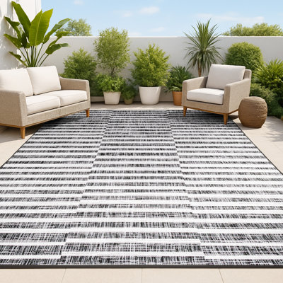 Tapis intérieur / extérieur noir / ivoire à rayures décalées Perrigo
