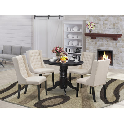 L'ensemble de table de cuisine 5 pièces pour 4 personnes comprend une table de salle à manger ronde avec piédestal et 4 chaises rembourrées en tissu crème, noir