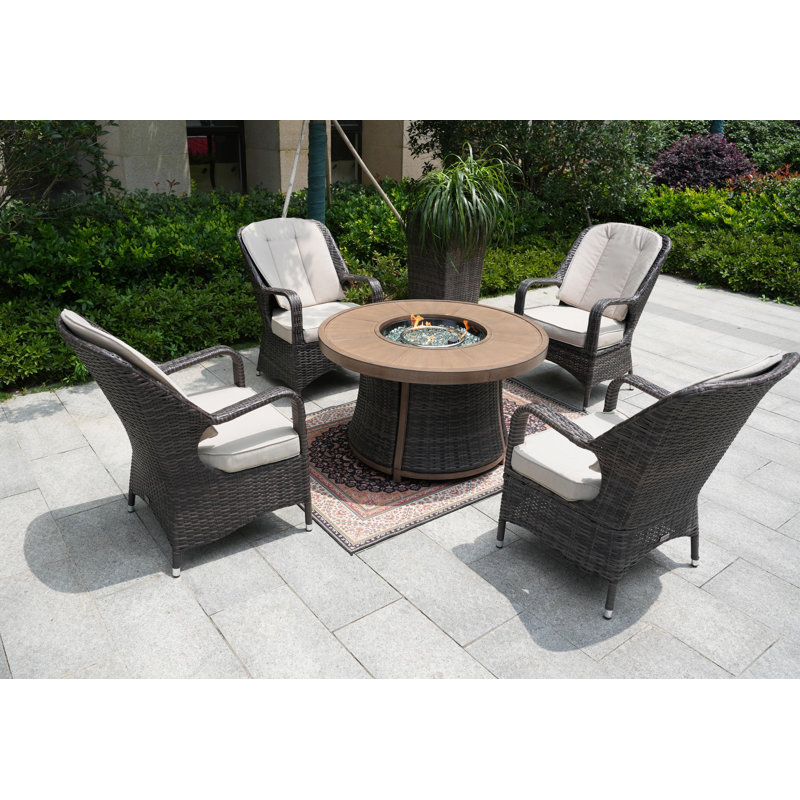 Areefa 4 - Person Wicker Patio Dining Set with Round Table , Cushions Included