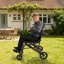 Fauteuil roulant de voyage portatif en acier pliable, léger et équipé d'un frein à main, pour personnes âgées et à mobilité réduite.