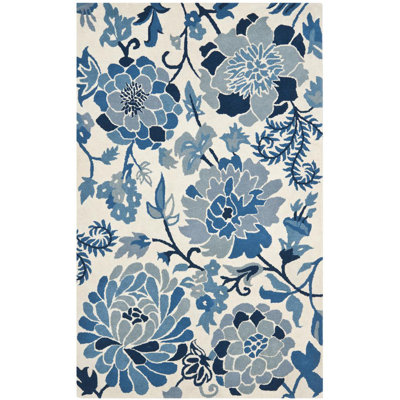 Coreatha Hand Tufted Wool/Cotton Floral Rug in Azurite/Cream/Black
