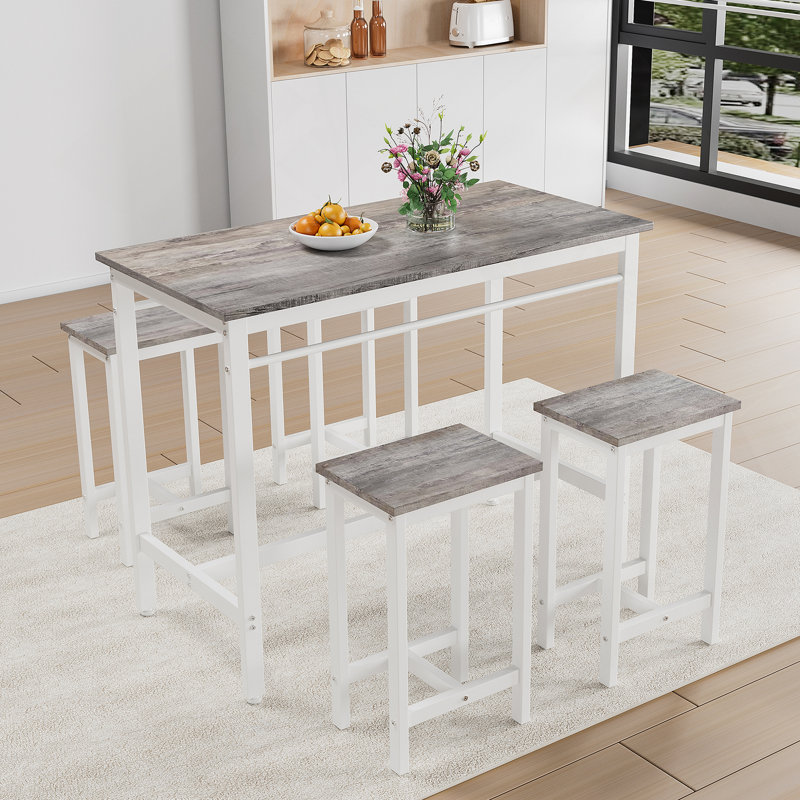 Ensemble de table de cuisine moderne cinq pièces avec quatre tabourets de bar, idéal pour les dîners de famille et les petites réunions, multifonctionnel pour divers espaces.