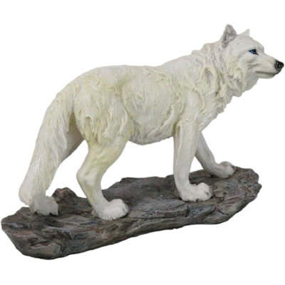 Figurine loup blanc albinos sur la forêt