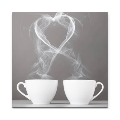 Leinwandbild Herzsilhouette aus dampfenden Kaffeetassen