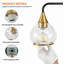 Éclairage pour salle de bain 4 lumières Mid-Century moderne avec élégants globes en verre transparent noir mat et or-129899852