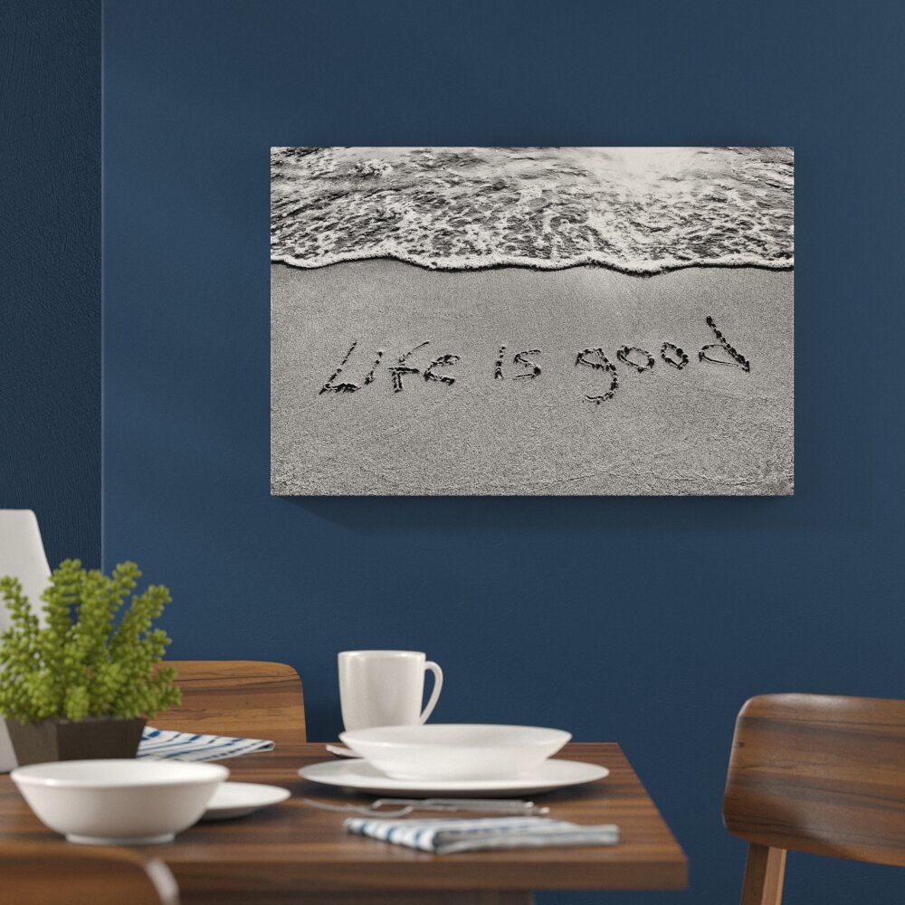 Leinwandbild Schrift im Sand Life is good in Monochrom