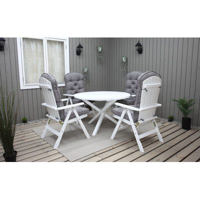 Capuano 4 - Person Wood Patio Dining Set with Round Table , Cushions Included