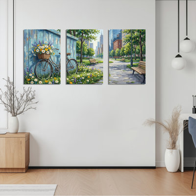 Ensemble de 3 tableaux sur toile représentant un vélo avec panier de fleurs et un paysage de parc urbain