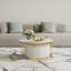 Table basse gigogne ronde en 2 parties, plateaux en faux marbre, base de rangement cannelée, 2 tiroirs et détails en métal doré