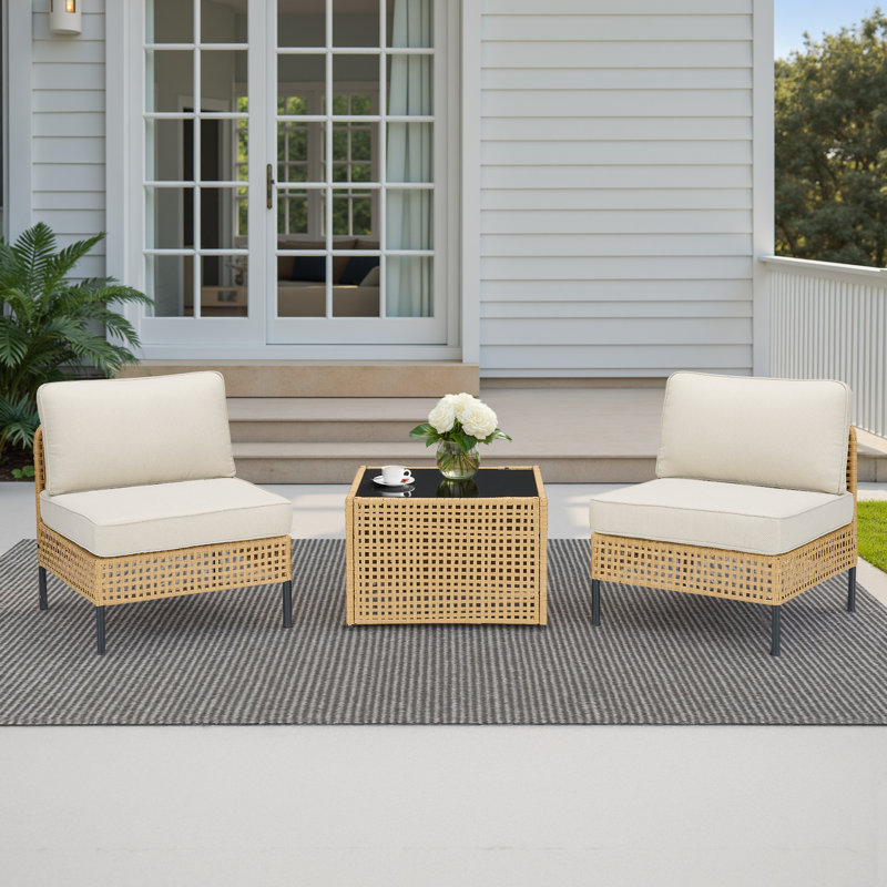 Ensemble de mobilier de patio modulaire en osier 3 pièces Bay Isle Home ™, fauteuil d'extérieur en rotin et coussins avec table en verre