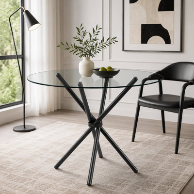 Table de salle à manger ronde en verre avec pieds en métal en forme d'anneau