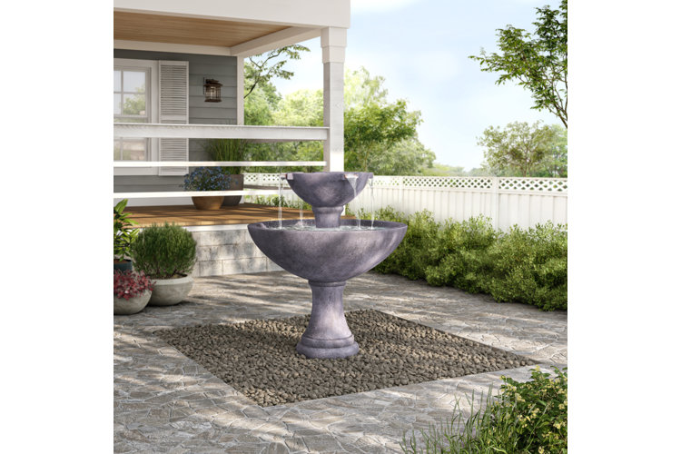 gray fountain in a gravel area