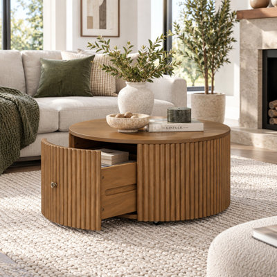 Table basse ronde cannelée en forme de tambour avec roulettes et 2 tiroirs de rangement dissimulés