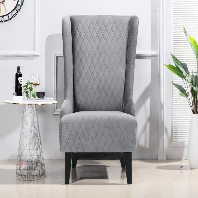 Fauteuil à oreilles haut dossier en velours avec coutures en losanges et pieds en bois de bouleau, Gris